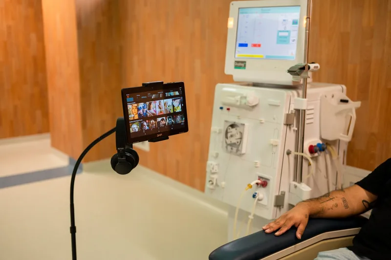 Patient during a hemodialysis session with an entertainment screen